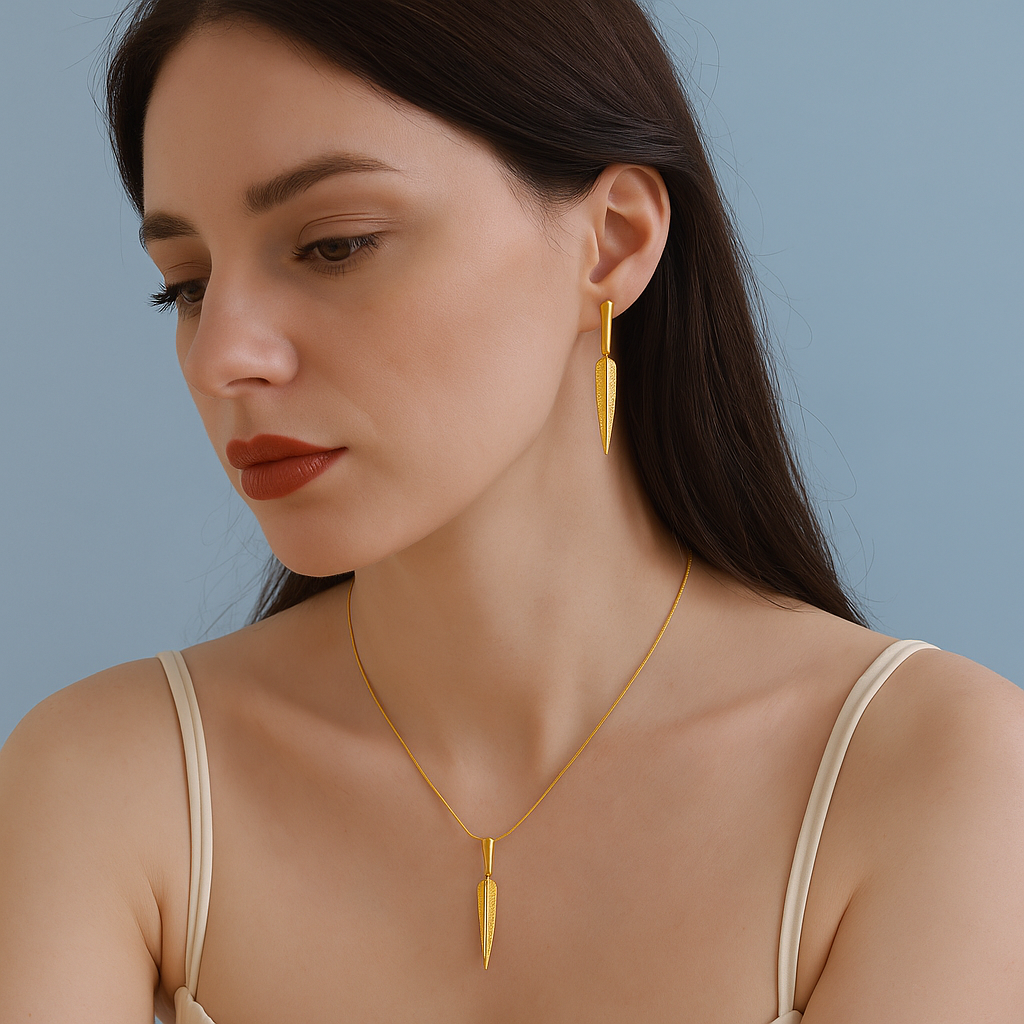 Gold necklace on a white fabric background with dried flowers