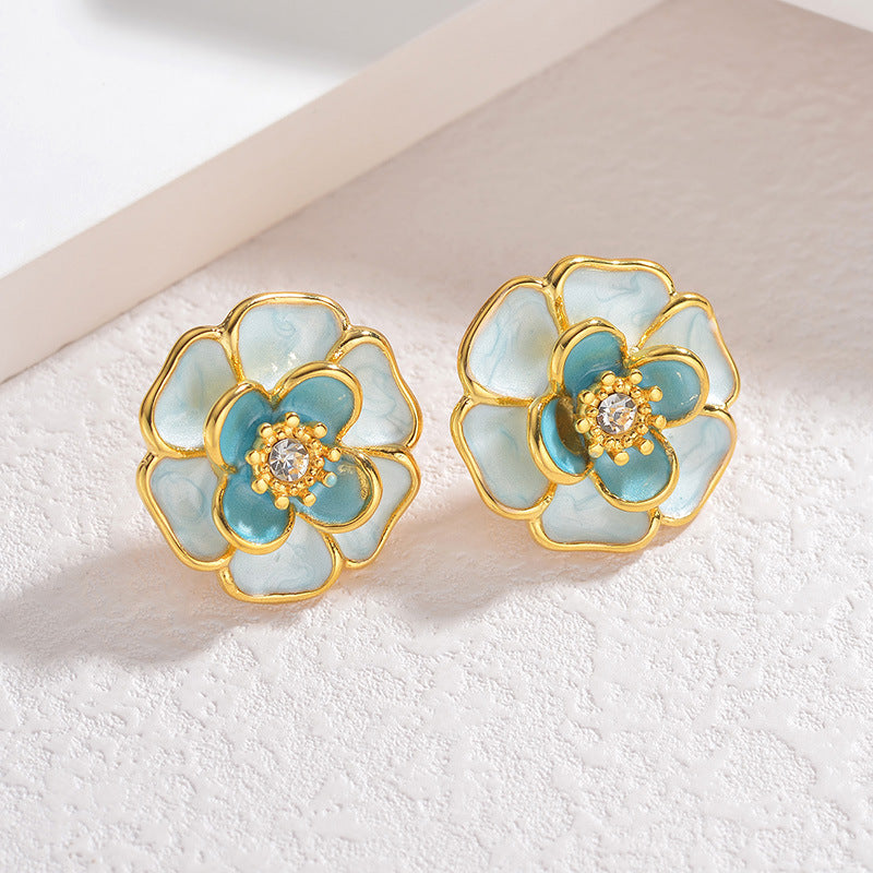 Floral earrings with gold and teal design 